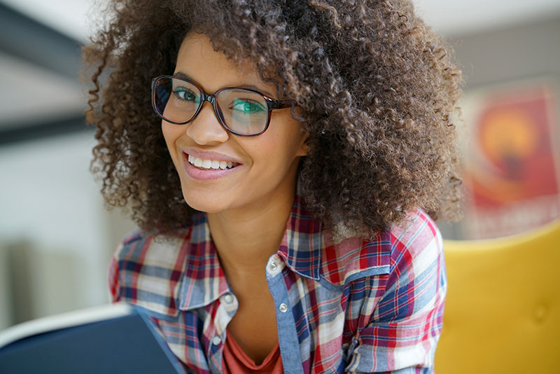 young african american female smiling wearing glasses